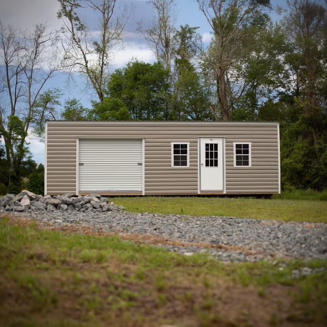 A portable storage building leveled on a sloped hill