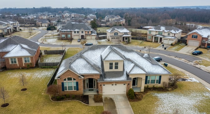 A suburban neighborhood in the winter with a light layer of snow