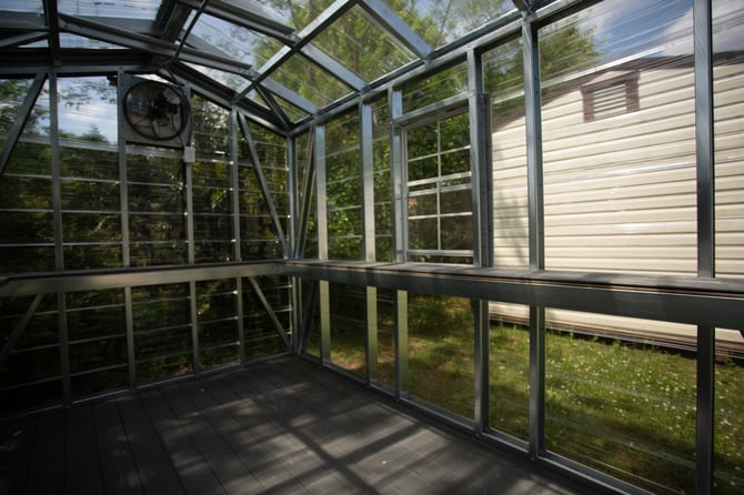 The interior of a greenhouse on a residential lot
